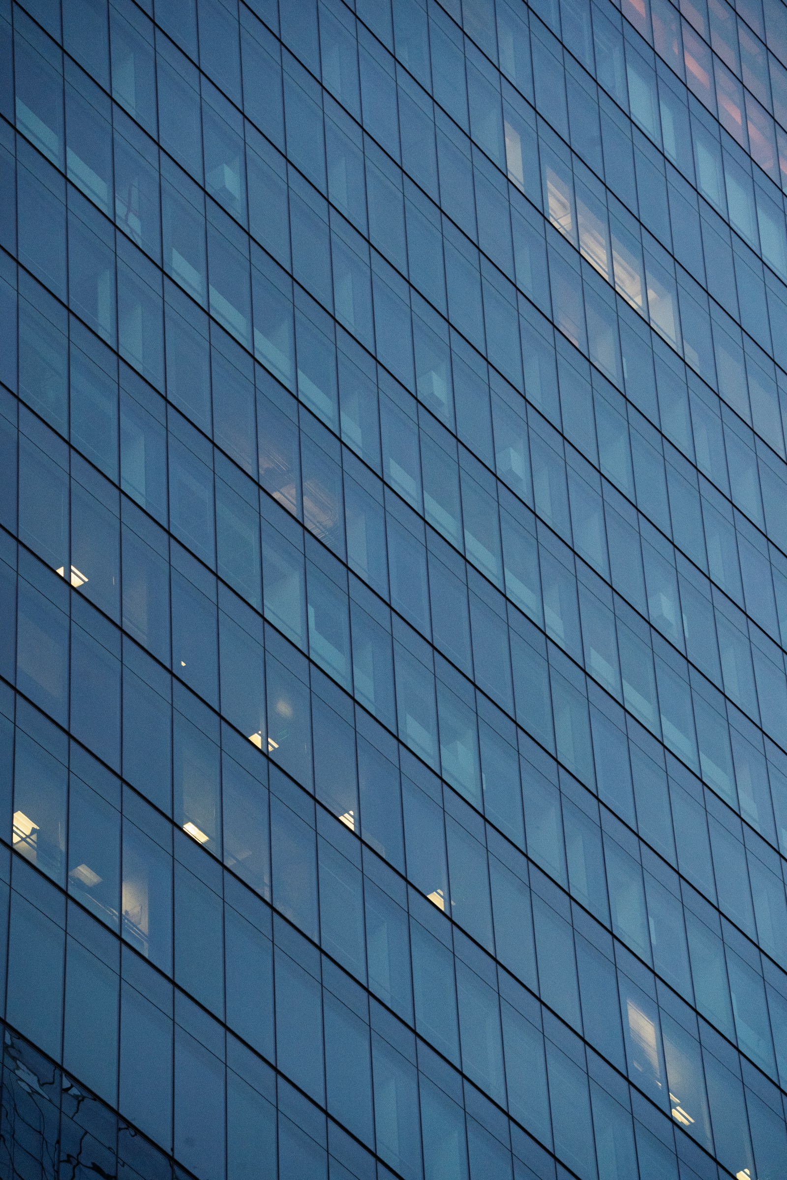 Blue glass curtain-wall facade on a modern office building